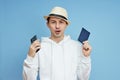 Man portrait tourist with a passport in hand, man in the hat