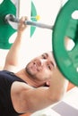 Man, portrait and weightlifting in a gym with athlete wellness and smile from workout. Fitness, happy bodybuilder and