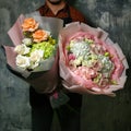 Man Holding Two Large Bouquets of Flowers Royalty Free Stock Photo