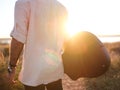 man posing backwards holding his guitar and watching the sunset Royalty Free Stock Photo