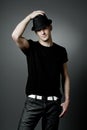 Man posing in black t-shirt and black hat. Royalty Free Stock Photo