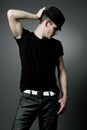 Man posing in black t-shirt and black hat. Royalty Free Stock Photo