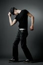 Man posing in black t-shirt and black hat. Royalty Free Stock Photo