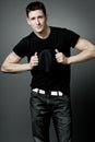 Man posing in black t-shirt and black hat. Royalty Free Stock Photo