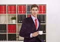 Man posing with coffee cup in office Royalty Free Stock Photo