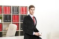 Man posing with coffee cup in office Royalty Free Stock Photo