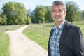 Man posing in country lane