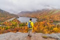 Man posing in front of beautiful Echo Lake from Artists Bluff Loop in New Hampshire USA Royalty Free Stock Photo