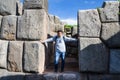 Man posing in front of the huge rocks of Sacsayhuaman in Cusco - Peru Royalty Free Stock Photo