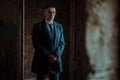 A man posing in the image of an English retro gangster in Peaky blinders style