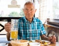 Man posing with a mug of beer at lunch in a restaurant Royalty Free Stock Photo