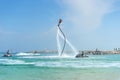 Man posing at new flyboard at Caribbean tropical beach. Positive