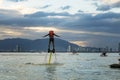 Man posing at new flyboard at tropical beach at sunset. Positive human emotions, feelings, joy. Funny cute men making vacations Royalty Free Stock Photo