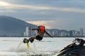 Man posing at new flyboard at tropical beach at sunset. Positive human emotions, feelings, joy. Funny cute men making vacations Royalty Free Stock Photo