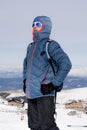 Man posing after peak summit trekking achievement in snow mountain on winter landscape