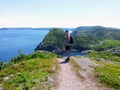 A man posing for a photo with beautiful views hiking the east coast trail off the coast of Newfoundland and Labrador, Canada. Royalty Free Stock Photo