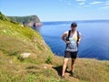 A man posing for a photo with beautiful views hiking the east coast trail off the coast of Newfoundland and Labrador, Canada. Royalty Free Stock Photo