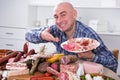 Man posing with a plate of cold cuts Royalty Free Stock Photo