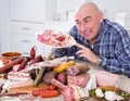 Man posing with a plate of cold cuts Royalty Free Stock Photo