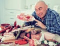 Man posing with a plate of cold cuts Royalty Free Stock Photo