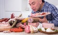 Man posing with a plate of cold cuts Royalty Free Stock Photo