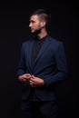 Man posing studio elegant suit, looking sideways Royalty Free Stock Photo