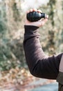 Man posing to throw a grenade raising his hand