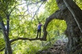 Man posing on tree branch on trail