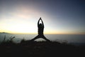 Man posing yoga on top of misty mountain cliff Royalty Free Stock Photo