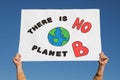 Man with poster protesting against climate change outdoors, closeup Royalty Free Stock Photo