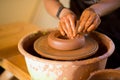 Man potter work with clay ware. Young man potter on his workshop with nature background