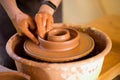 Man potter work with clay ware. Young man potter on his workshop with nature background