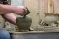 Man potter at work creating some traditional cups of white clay, Lassithi, Crete, Greece.