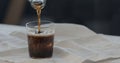 man pour cola over ice rocks into tumbler glass Royalty Free Stock Photo