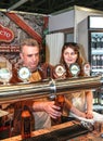 Man pouring beer to glass from beer tap