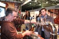 Man pouring beer to glass from beer tap