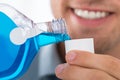 Man Pouring Bottle Of Mouthwash Into Cap Royalty Free Stock Photo