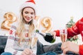 man pouring champagne into glasses for woman at home with 2019 new Royalty Free Stock Photo