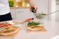 Man pouring cold pressed linseed oil on classic Italian bruschetta. Vegan healthy food Royalty Free Stock Photo