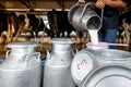 One man is pouring milk to milk tank in a dairy farm