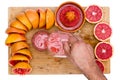 Man pouring freshly squeezed ruby grapefruit juice