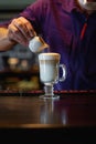 Man pouring frothed milk into espresso making latte coffee Royalty Free Stock Photo