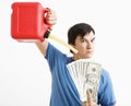 Man pouring gas on money. Royalty Free Stock Photo