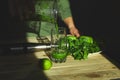 Man pouring in glass healthy detox smoothie, cooking with blender with fresh fruits and greens spinach