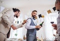 A man pouring guests wine on a indoor family birthday party. Royalty Free Stock Photo