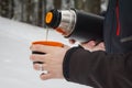 Man pouring hot tea from a vacuum flask Royalty Free Stock Photo