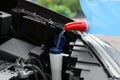 Man pouring liquid from  canister into car washer fluid reservoir, closeup Royalty Free Stock Photo