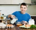 Man pouring milk in bowl Royalty Free Stock Photo