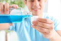 Man pouring mouthwash from bottle into cap, closeup. Royalty Free Stock Photo