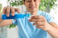 Man pouring mouthwash from bottle into cap, closeup Royalty Free Stock Photo